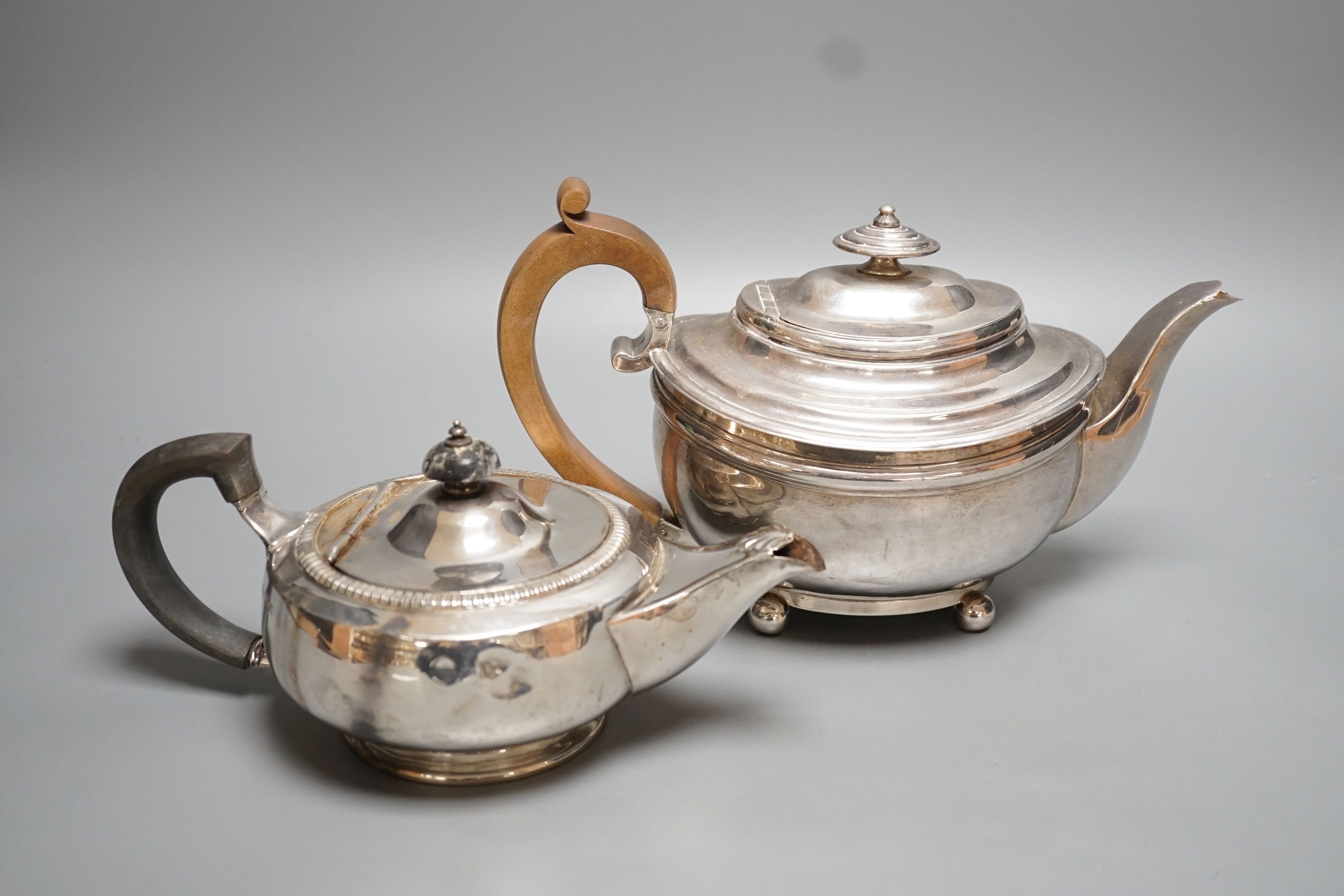 A George III silver teapot, Soloman Hougham, London, 1816 and a 20th century squat silver teapot, gross 31.5oz.